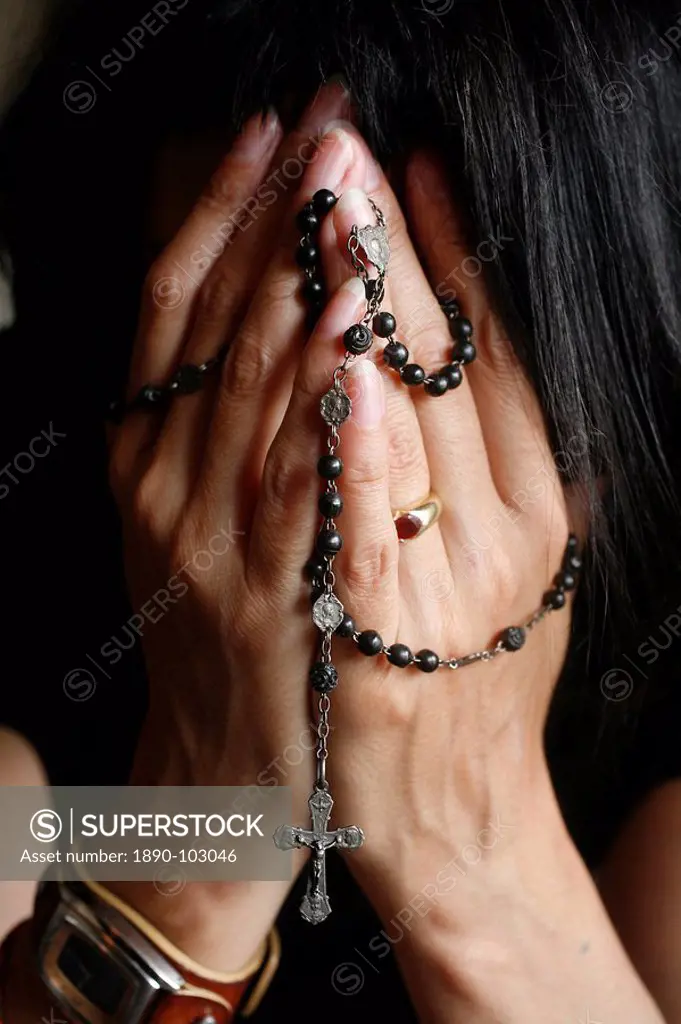 Woman praying with rosary, Chatillon_sur_Chalaronne, Ain, France, Europe