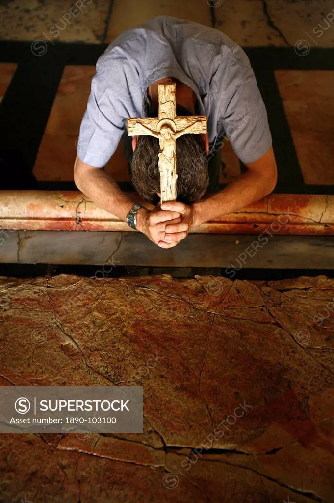 Worshipper at the Stone of the Anointing, Church of the Holy Sepulchre, Jerusalem, Israel, Middle East