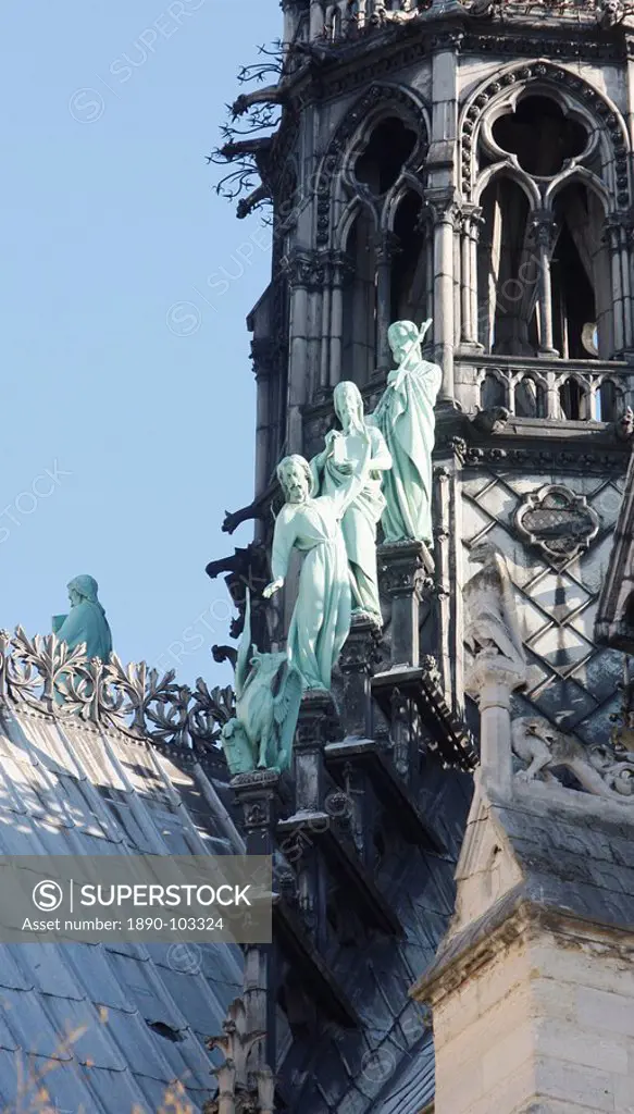 Statues of three apostles at the foot of Notre_Dame_De_Paris cathedral spire, Paris, Ile de France, France, Europe