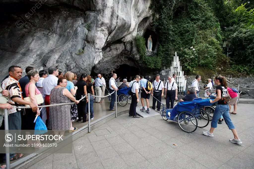 Pilgrims at the Lourdes grotto, Lourdes, Hautes Pyrenees, France, Europe