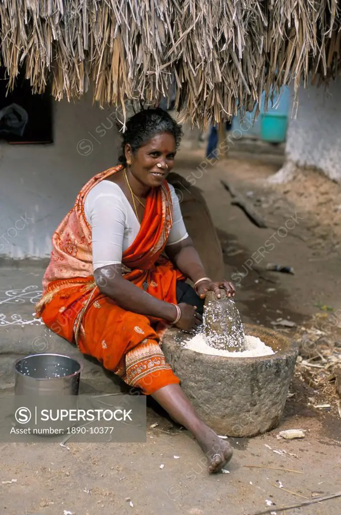 Village woman pounding rice, Tamil Nadu, India, Asia