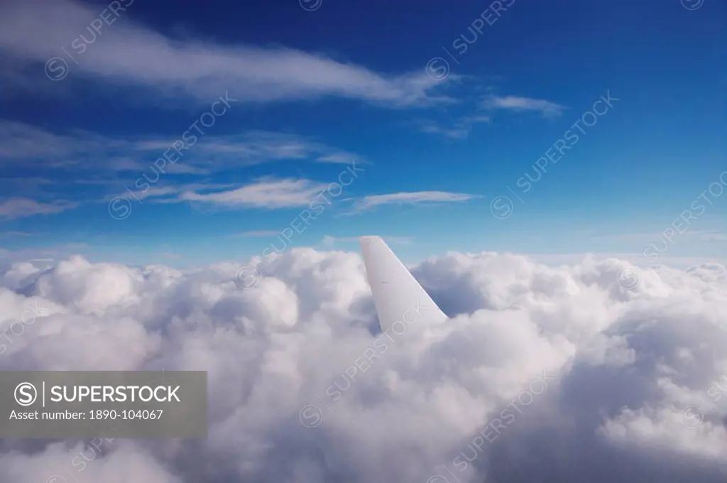 Aircraft tail fin in clouds
