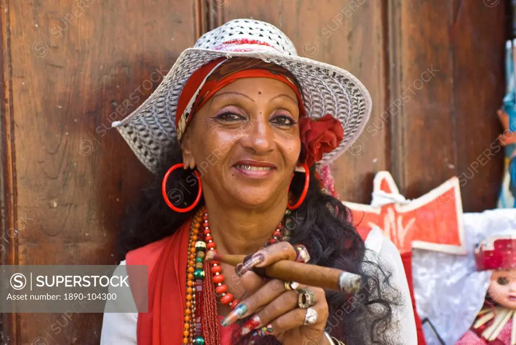Typical dressed Cuban woman smoking a giant cigar, Havana, Cuba, West Indies, Central America