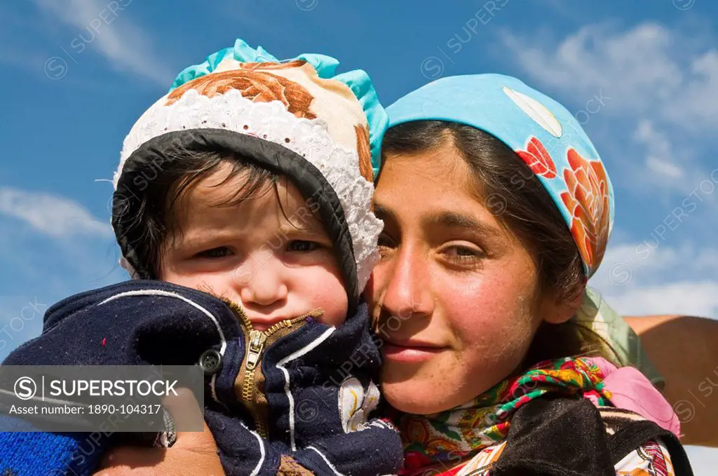 Young Pamir girl holding her little brother, Tajikistan, Central Asia, Asia