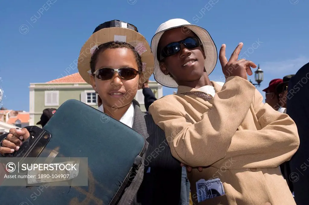 Young men dressed as businesspeople during Carnival, Mindelo, Sao Vicente, Cape Verde, Africa