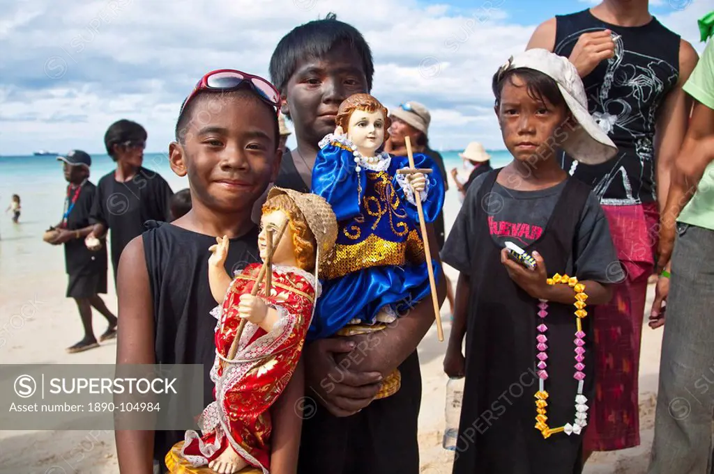Boys, with soot smeared on their faces, in the parade along White Beach during the Ati_Atihan Festival, an annual feast in honour of the Santo Nino, B...