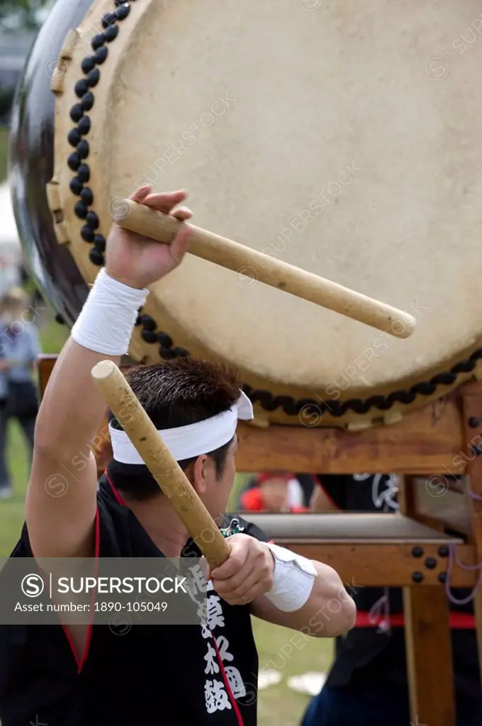Drummer performing on a Japanese taiko drum at a festival in Kanagawa, Japan, Asia