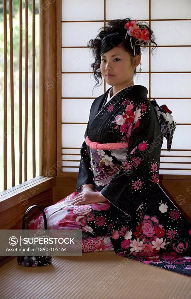 A 20_year old Japanese girl wearing spring furisode kimono with long sleeves to indicate her single social status, Japan, Asia