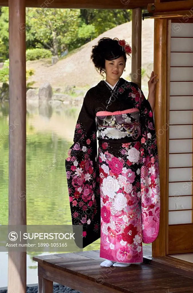 A 20_year old Japanese girl wearing spring furisode kimono with long sleeves to indicate her single social status, Japan, Asia