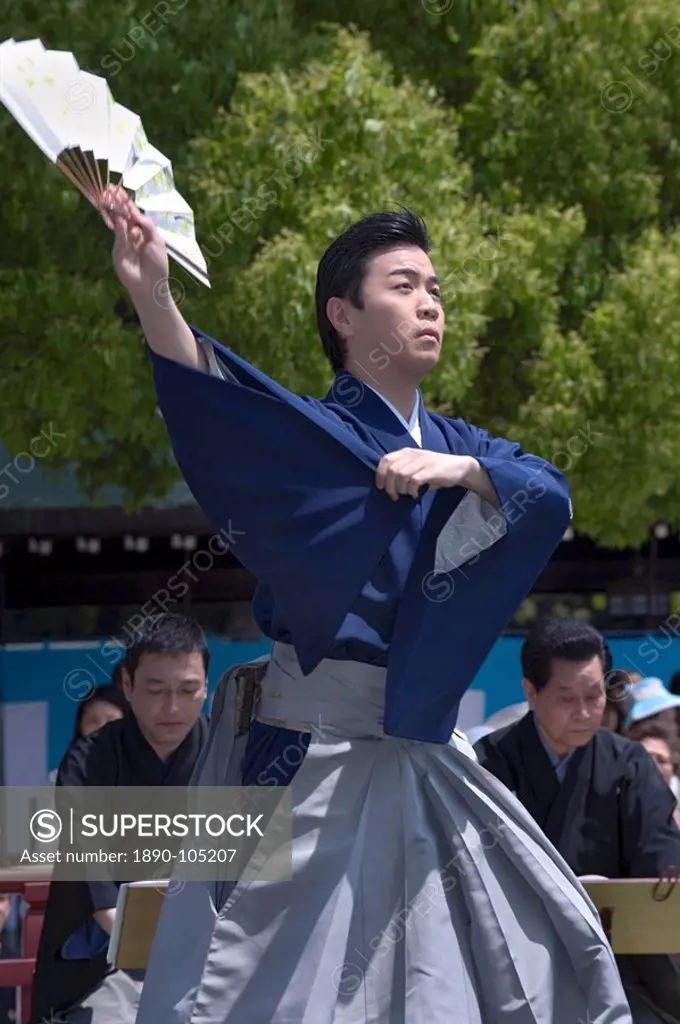 Man with fan performing classical Japanese dance called hobu at Meiji Jingu shrine, Tokyo, Japan, Asia