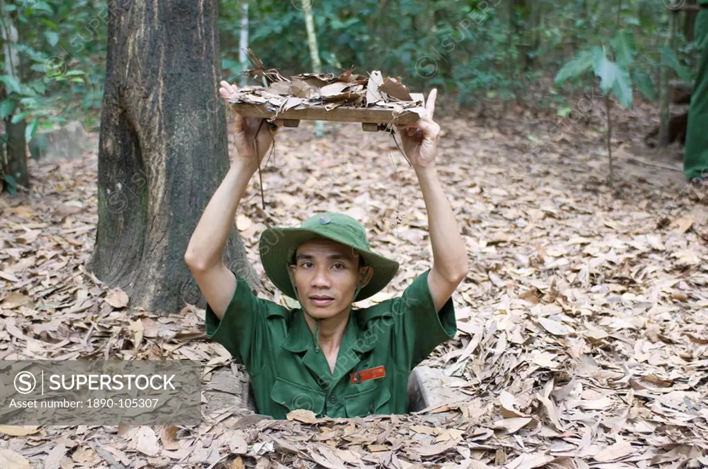 Soldier showing the entrance to the former Viet Cong tunnels of ChuChi, near Saigon, Vietnam, Indochina, Southeast Asia, Asia
