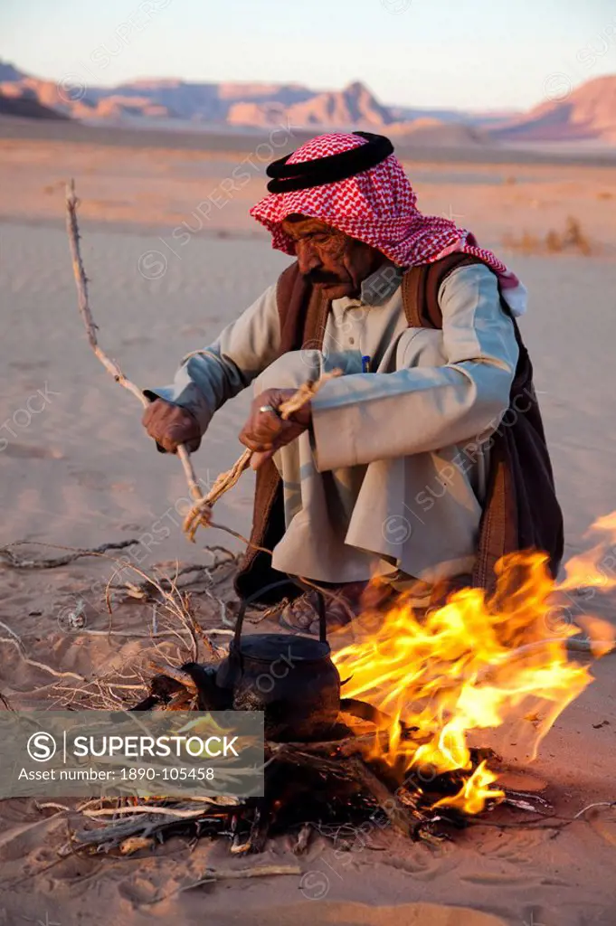 Bedouin making tea on open fire in the desert of Wadi Rum, Jordan, Middle East