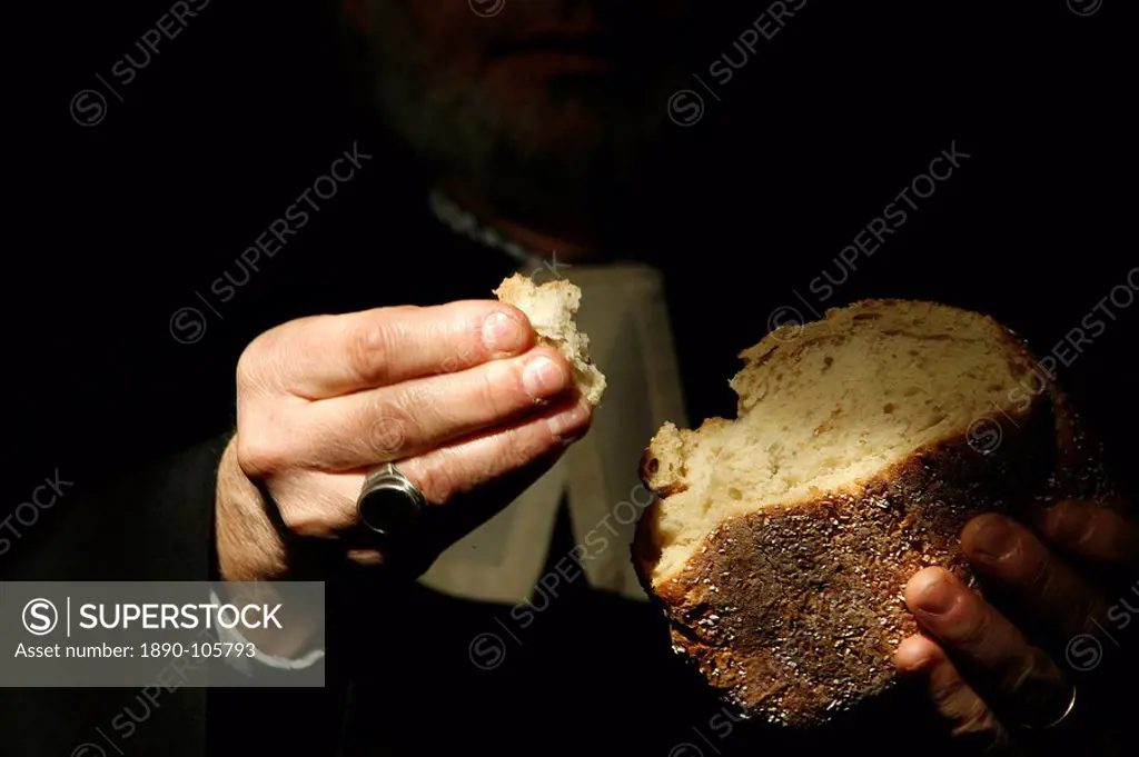 Protestant minister holding Communion bread, Geneva, Switzerland, Europe