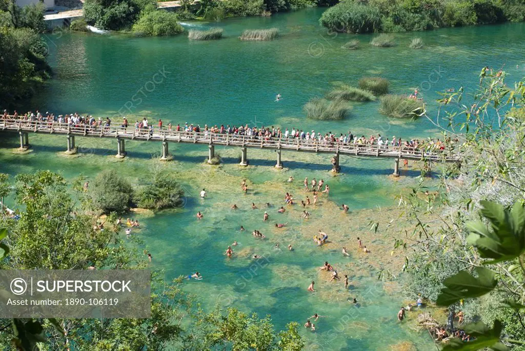 Bridge with many tourists above turquoise water in the Krka National Park, Croatia, Europe