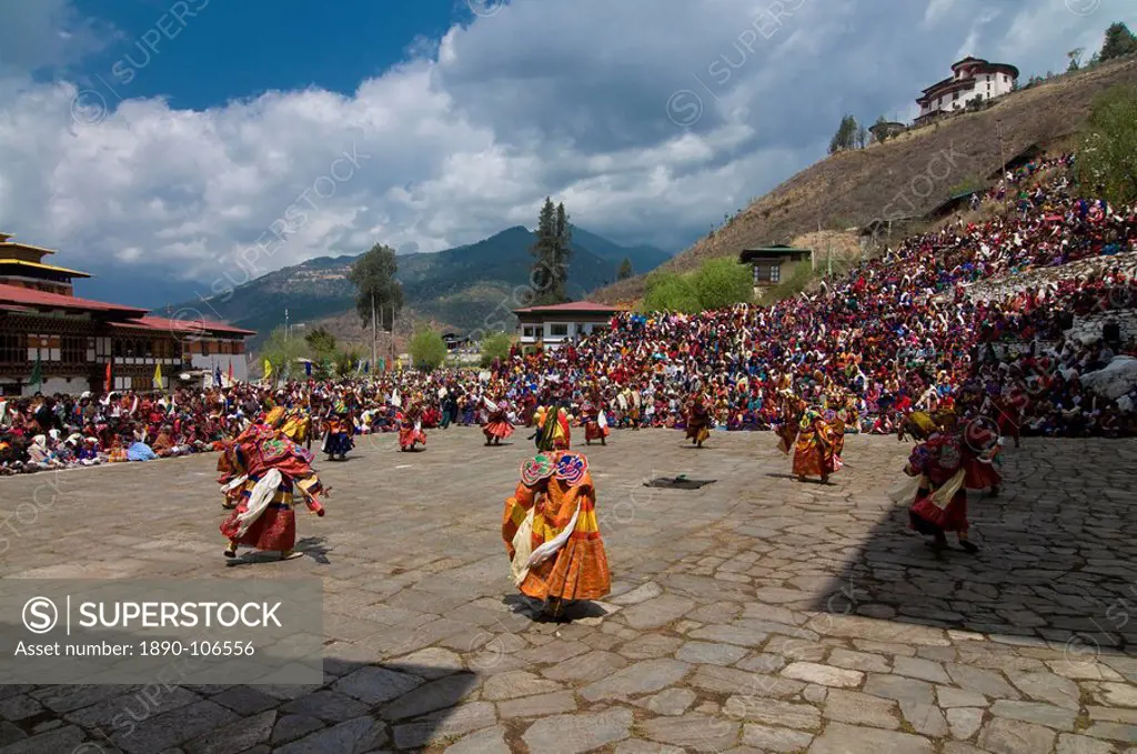 Costumed dancers at religious festival with many visitors, Paro Tsechu, Paro, Bhutan, Asia