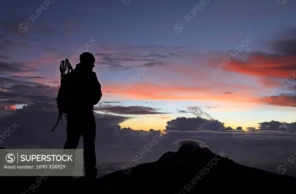 A climber looks towards Mawenzi from near the summit of Mount Kilimanjaro at dawn, Tanzania, East Africa, Africa