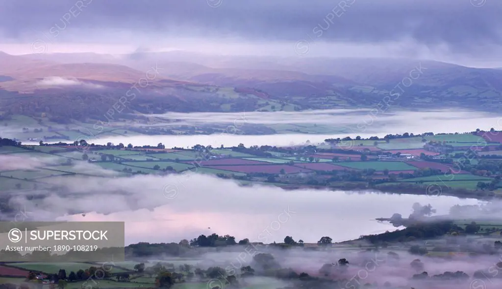 Llangorse Lake and the Brecon Beacons mountain range at dawn on a misty morning, Brecon Beacons National Park, Powys, Wales, United Kingdom, Europe