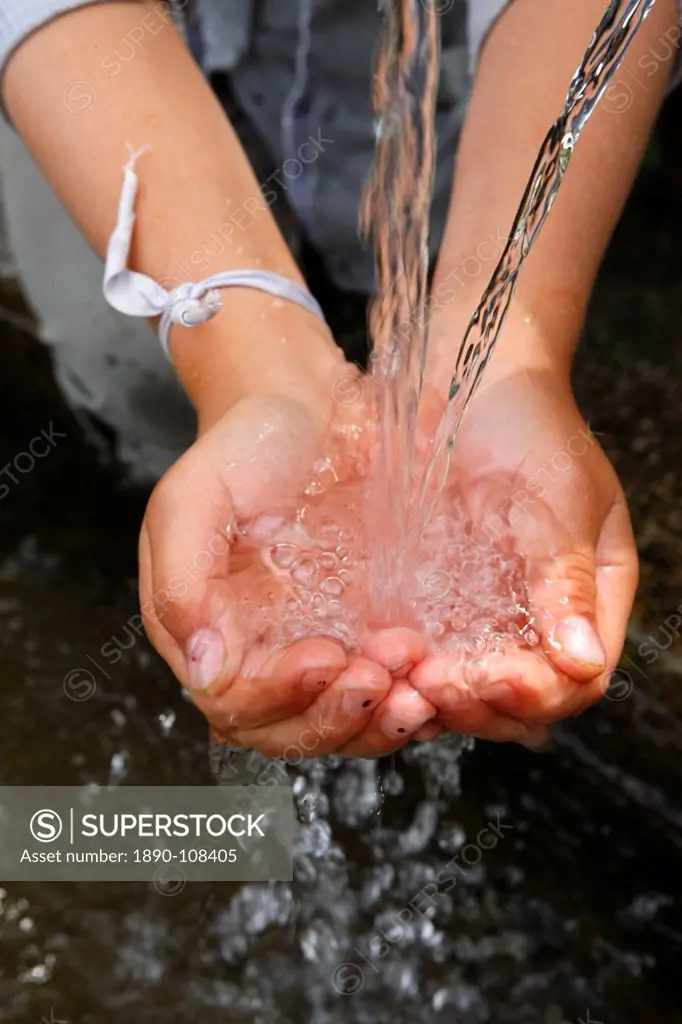 Child´s hand with water, France, Europe