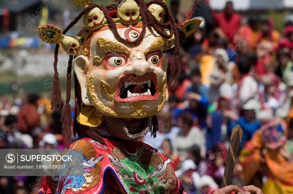 Masked dancer at religious festival with many visitors, Paro Tsechu, Paro, Bhutan, Asia