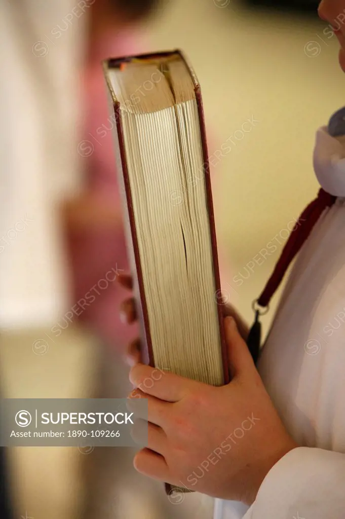 Altar boy carrying book, France, Europe
