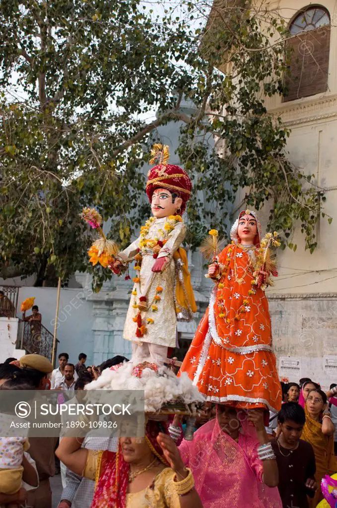Sari clad women carrying idols at the Mewar Festival in Udaipur, Rajasthan, India, Asia