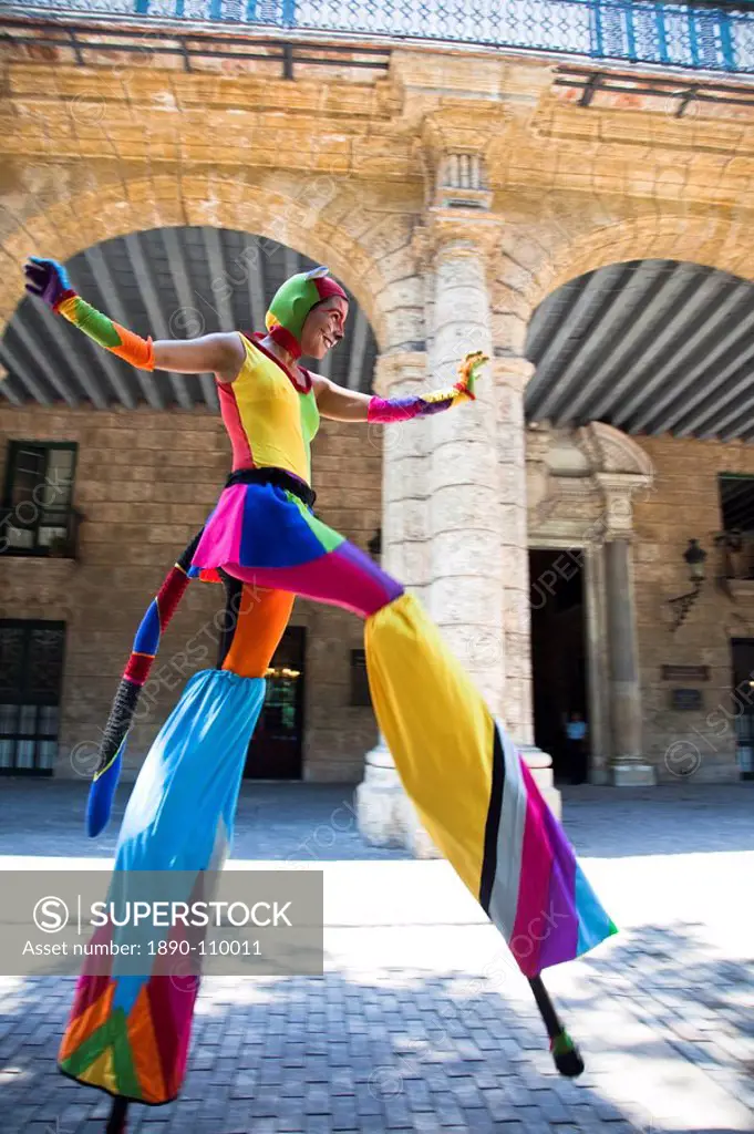 Performer in the street in Old Havana walking on stilts, Havana, Cuba, West Indies, Central America