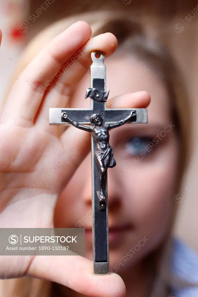 Teenage girl holding a crucifix, Saint Gervais, Haute Savoie, france, Europe