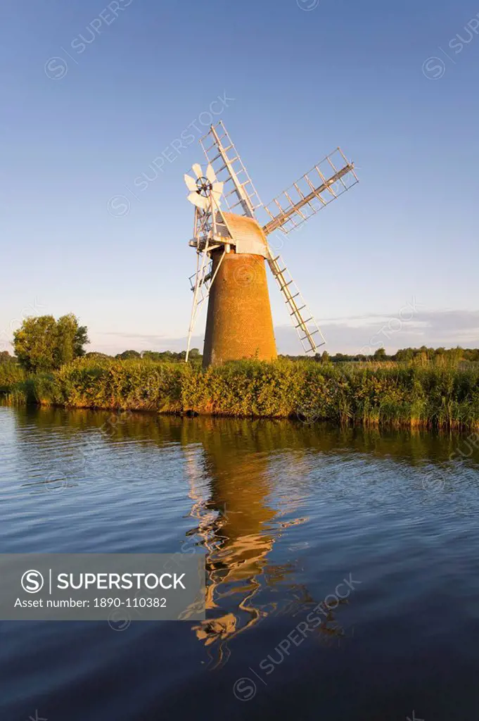 Turf Fen windmill reflected in the River Ant at sunrise, Norfolk Broads, How Hill, near Ludham, Norfolk, England, United Kingdom, Europe