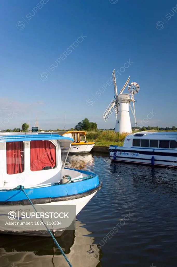 Pleasure boats moored beside Thurne windmill, Norfolk Broads, Thurne, Norfolk, England, United Kingdom, Europe