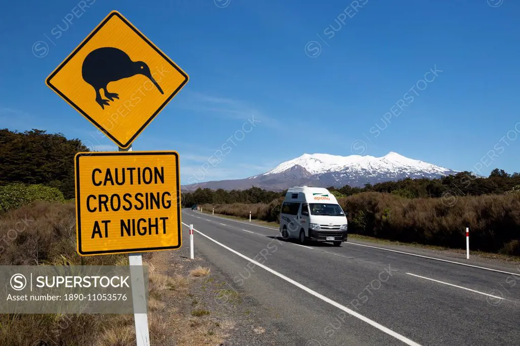Motorhome below Mount Ruapehu with Kiwi crossing sign, Tongariro National Park, UNESCO World Heritage Site, North Island, New Zealand, Pacific