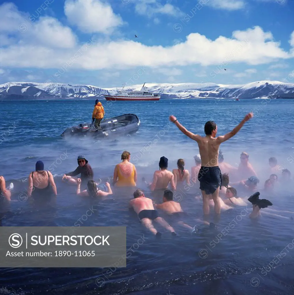 Tourists bathe in hot tub in warm waters of dormant volcano on Deception Island, Antarctica, Polar Regions