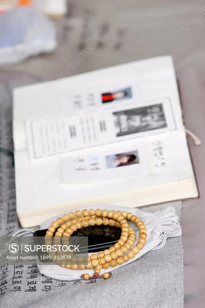 Religious book, prayer beads and mobile phone, Seoul, South Korea, Asia