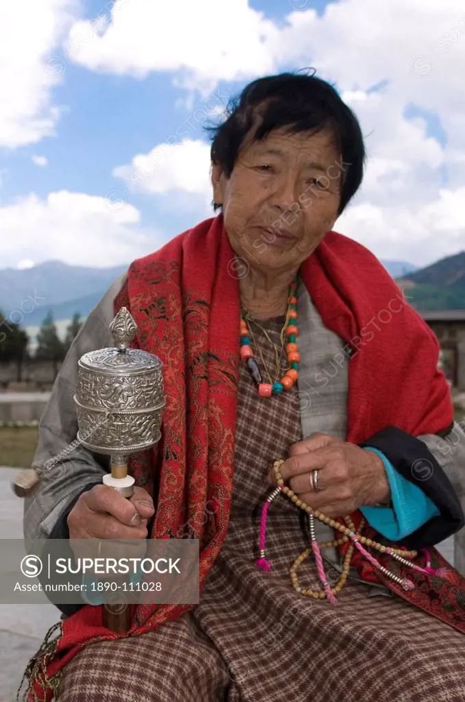 Buddhist pilgrim holding a prayer wheel, Thimpu, Bhutan, Asia