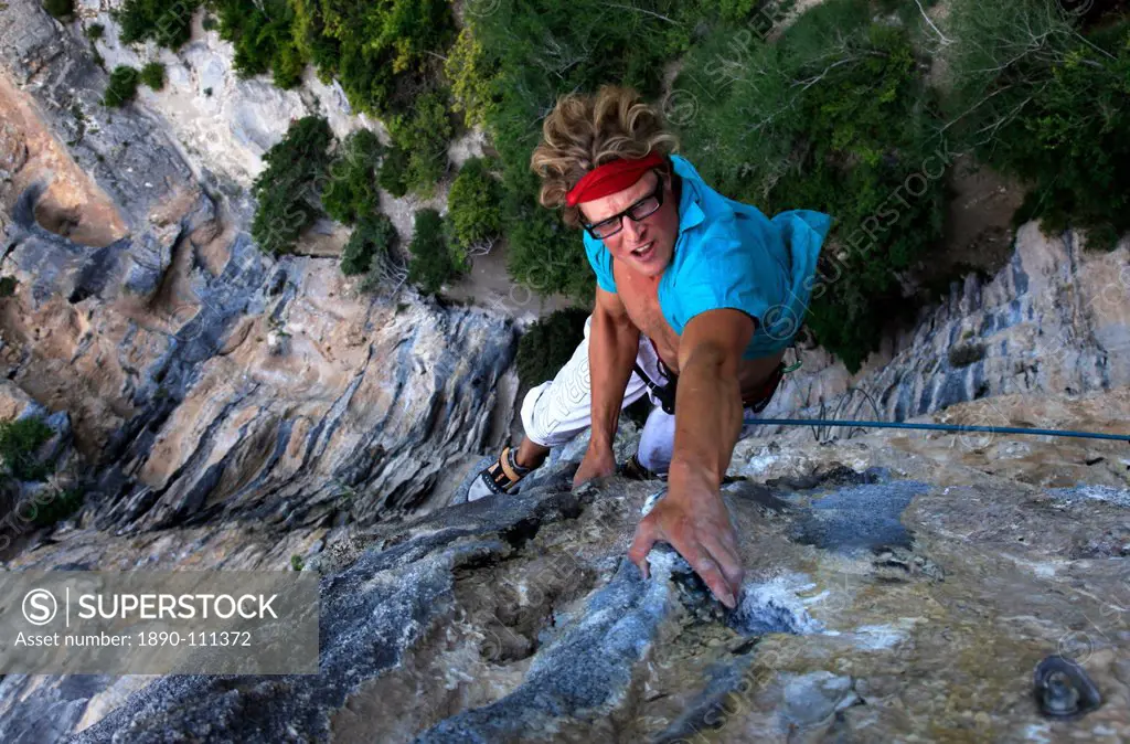 A man on a very long and overhanging climb on the famous limestone cliffs of the Mascun Canyon, Rodellar, Sierra de Guara, Aragon, southern Pyrenees, ...