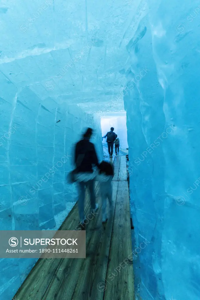 Tourists walking in the ice grotto inside Rhone Glacier, Gletsch, Canton of Valais, Switzerland, Europe