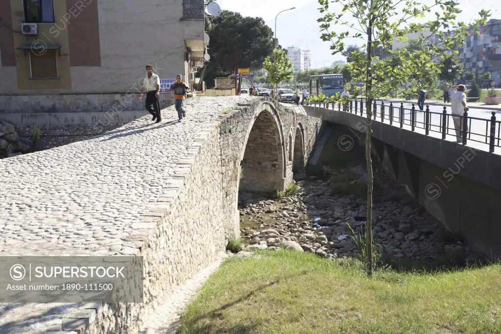 People walking over the Tanner´s bridge, an Ottoman stone footbridge in Tirana, Albania, Europe