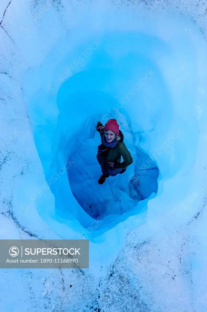 Woman standing in an Ice cave in the Fox Glacier, Westland Tai Poutini National Park, South Island, New Zealand, Pacific