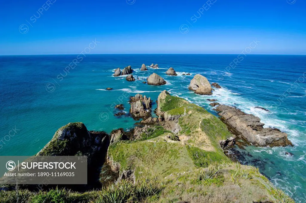 View from the Nugget Point Lighthouse in the turquoise waters with huge rocks, the Catlins, South Island, New Zealand, Pacific