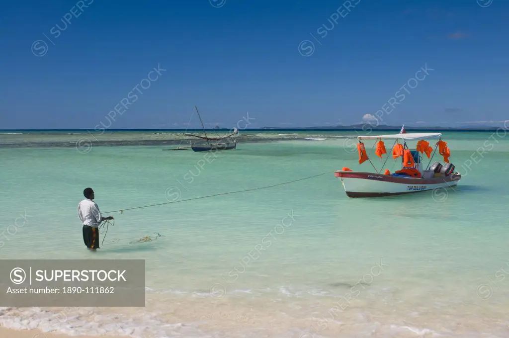 Man standing in the turquoise water of Nosy Iranja near Nosy Be, Madagascar, Africa
