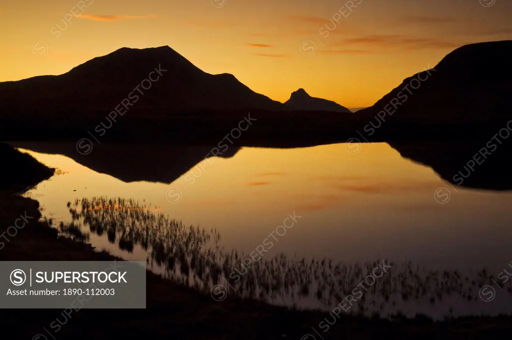 Sunset silhouette at Lochan an Ais, Inverpolly, Sutherland, north west Scotland, United Kingdom, Europe