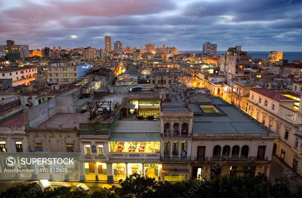 View over Havana Centro at night from 7th floor of Hotel Seville showing contrast of old, semi_derelict apartment buildings against a backdrop of more...