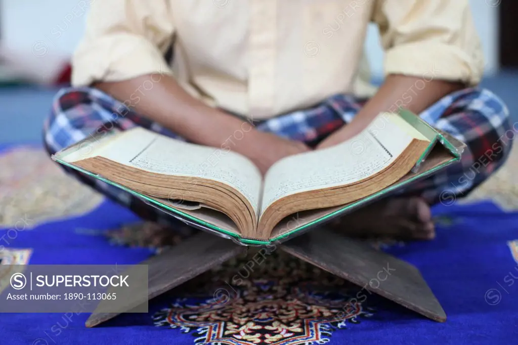 Muslim man reading the Quran in mosque, Ho Chi Minh City, Vietnam, Indochina, Southeast Asia, Asia