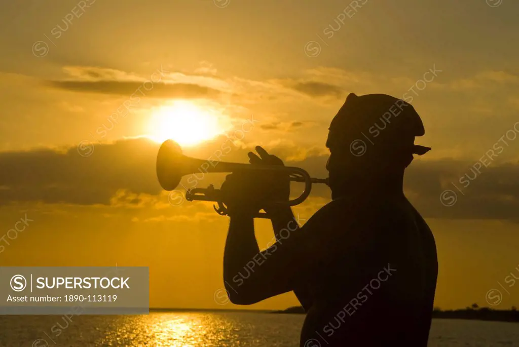 Trumpet player at sunset, Playa Ancon, Trinidad, Cuba, West Indies, Caribbean, Central America