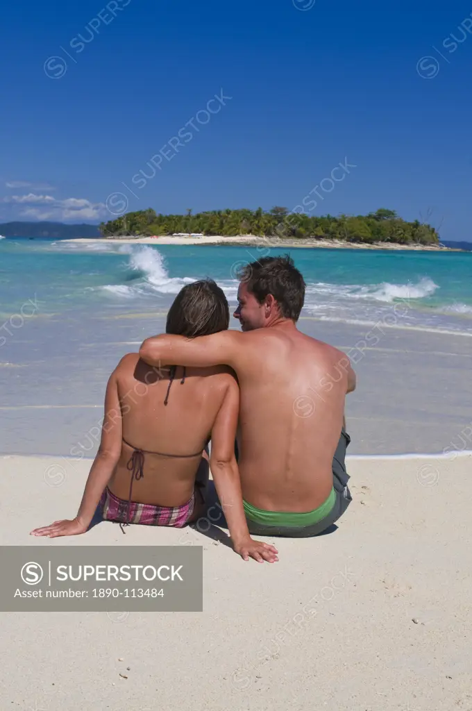 Happy couple on their honeymoon at the beautiful beach of Nosy Iranja near Nosy Be, Madagascar, Indian Ocean, Africa