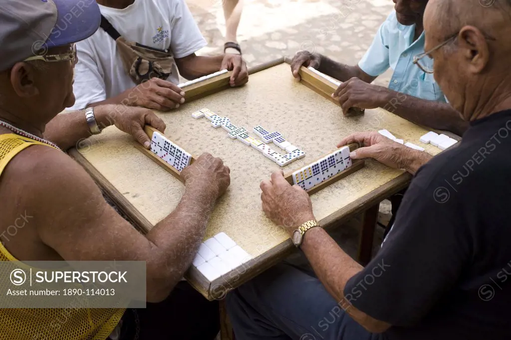 Old men playing dominos on street in Trinidad, Cuba, West Indies, Central America