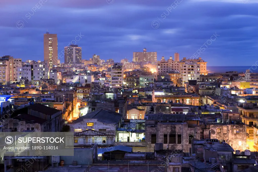 View over Havana Centro at night from Hotel Seville showing contrast of old, semi_derelict apartment buildings against a backdrop of more modern, affl...