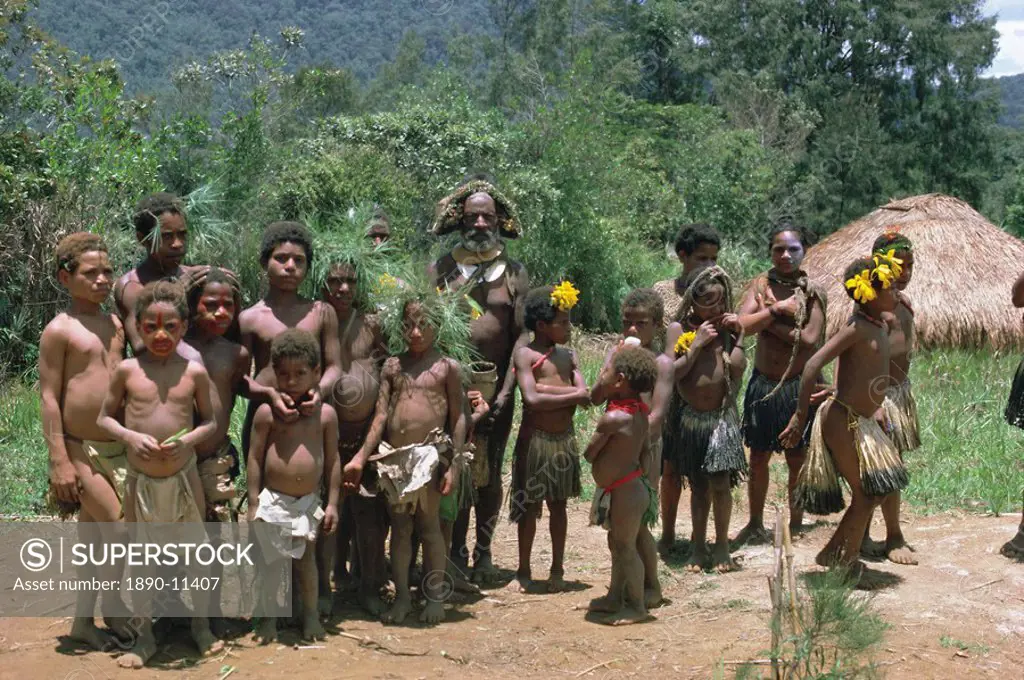 Portrait of a Huli man and group of children Highlands, Papua New Guinea, Pacific