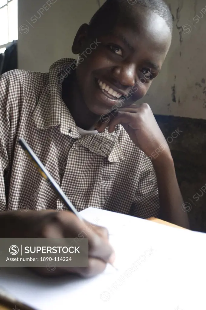 Schoolboy working happily at school, pupil at Murindati Primary School, Rift Valley, Kenya, East Africa, Africa