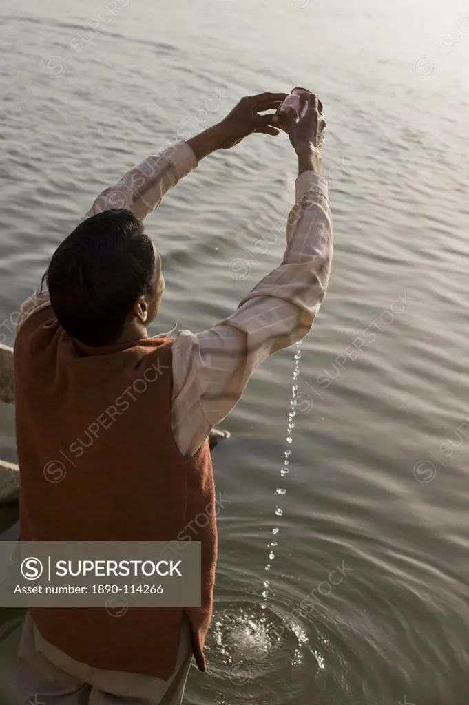 Hindu performing his daily devotion ritual to Ganga in Varanasi, Uttar Pradesh, India, Asia