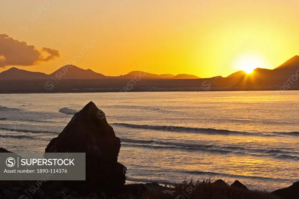 Sunset over the bay at Famara, Lanzarote´s finest surf beach in the north west of the island, Famara, Lanzarote, Canary Islands, Spain, Atlantic Ocean...